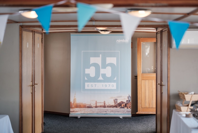 Bespoke branded pop-up banner and interior event styling setup on a Thames private charter vessel.